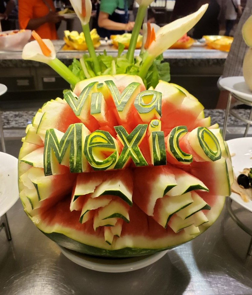 a carved watermelon that spells out Viva Mexico